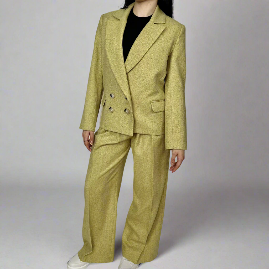 Dynamic angle showcasing Sartorial Flair’s mustard three-piece wool suit, underlining the structured fit and bespoke quality, ideal for those who value sustainability and enduring fashion.