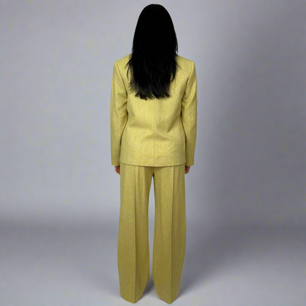 Back view of a mustard wool suit by Sartorial Flair, focusing on the meticulous craftsmanship and fit that emphasizes the brand’s commitment to eco-friendly fashion and classic style