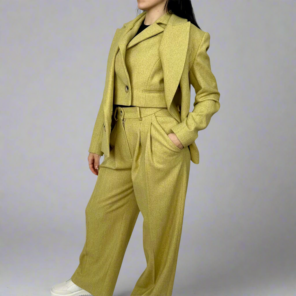 Mustard wool-blend three-piece suit for women, featuring a double-breasted blazer with peak lapels, tailored trousers, and a modern waistcoat, showcasing Sartorial Flair’s dedication to sustainable luxury and British tailoring.