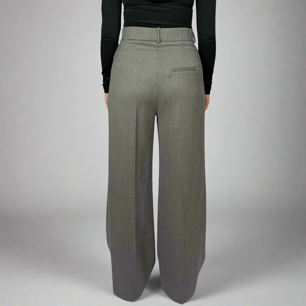 Rear view of Isabella Charcoal Trousers on a model, highlighting the expert tailoring and smooth, clean lines that define the back silhouette.