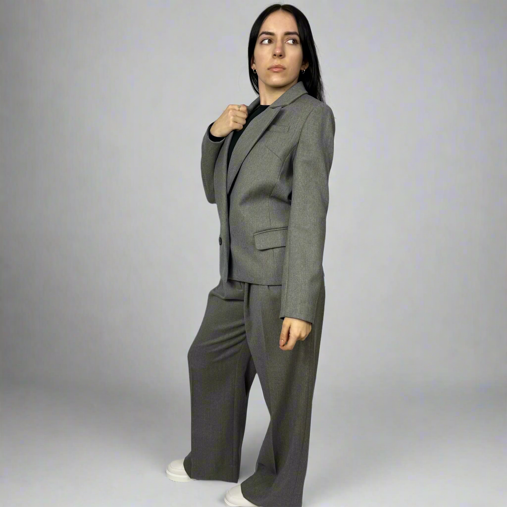 Side profile of the Isabella Blazer in charcoal grey, highlighting the precise tailoring and clean lines that make it ideal for a professional and stylish wardrobe.
