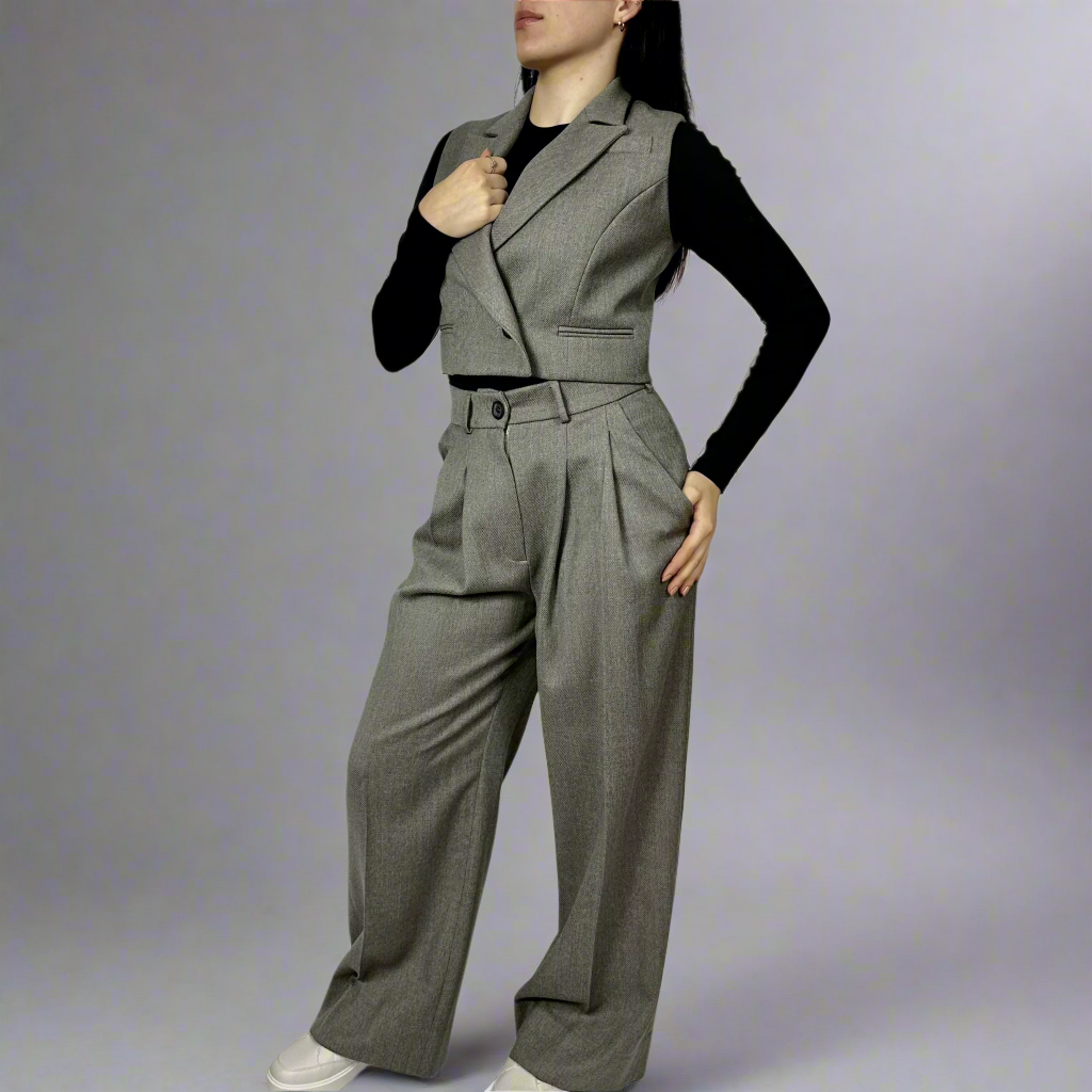 Side view of a model wearing the Isabella Waistcoat in charcoal gray, displaying the tailored fit and button detail.”