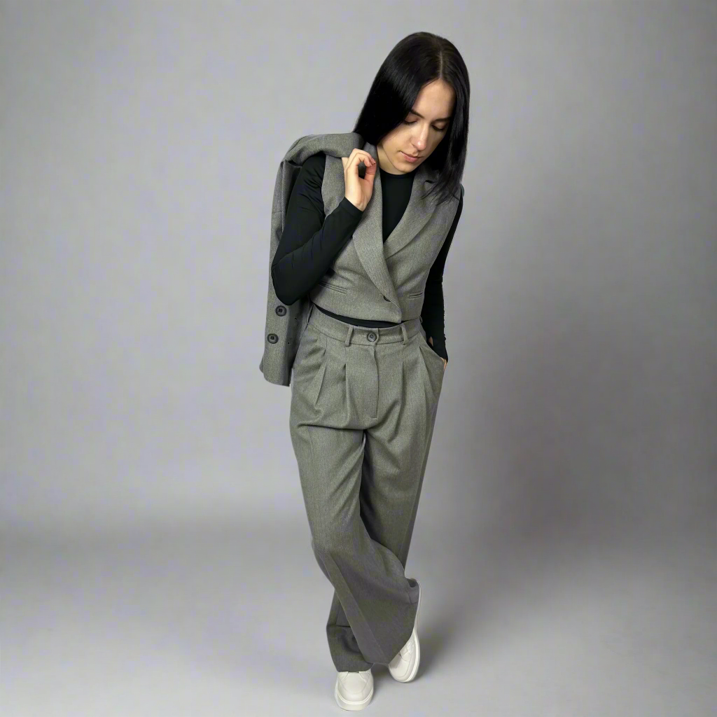 Model showcases the Isabella Waistcoat in charcoal gray, paired with matching trousers, emphasizing a professional and sleek look.